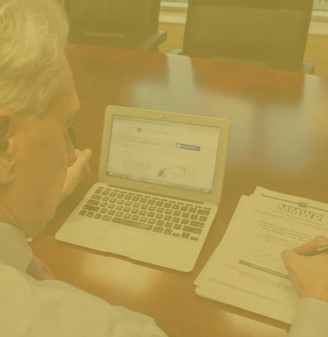 Medical Malpractice Attorney, S. Clark working on his laptop and a MMWR form of the side-Oklahoma city